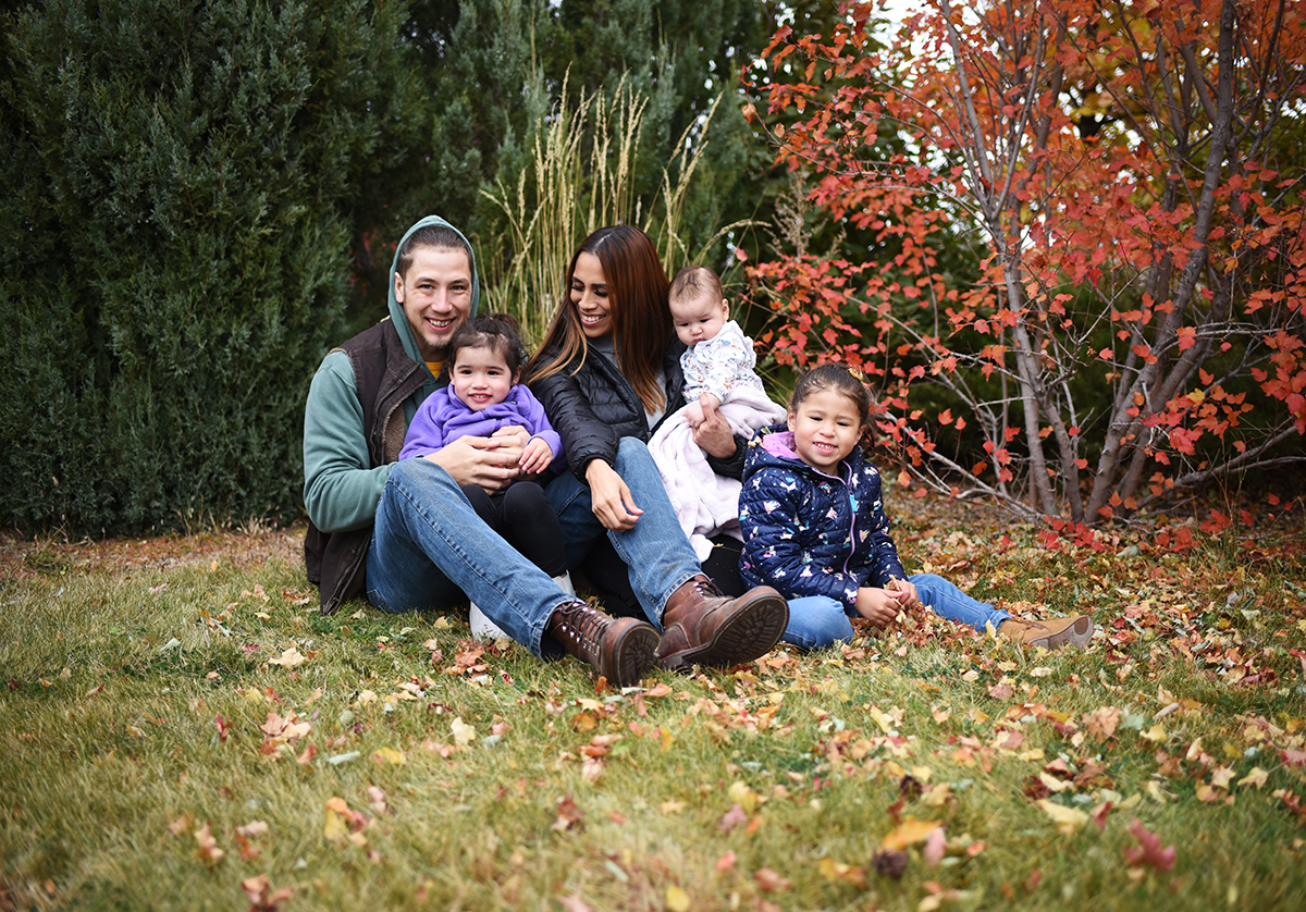 Photo of Nicole Alkire Grady with her family in a park.