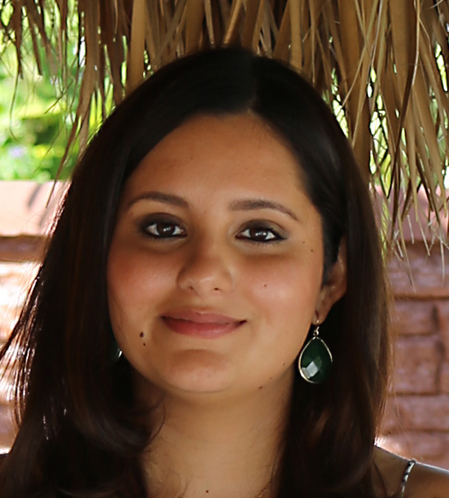 Headshot of Kathy Lugo facing the camera and smiling while standing outside.