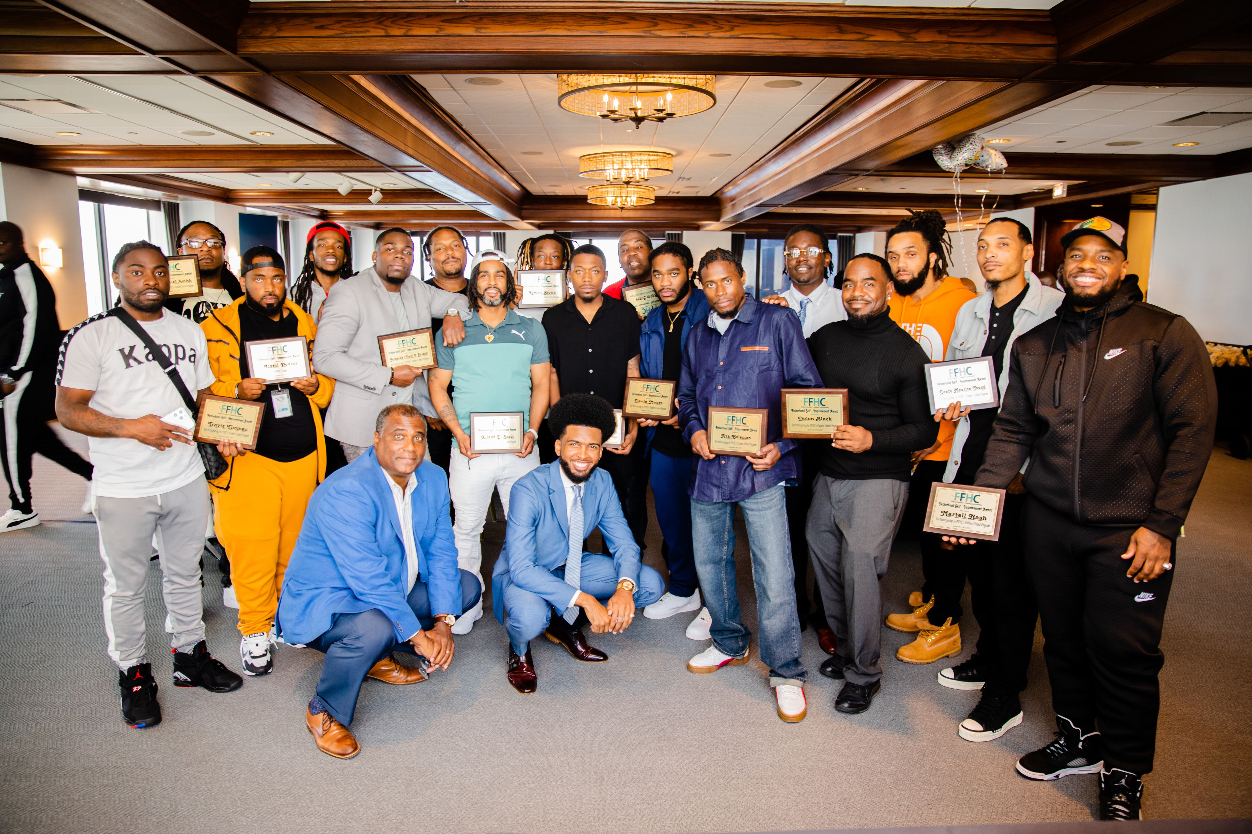 man holding baby's hand